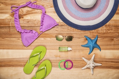 Flat lay composition with beach objects on wooden background