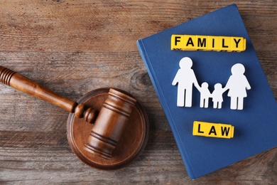 Flat lay composition with figure and gavel on wooden background. Family law concept