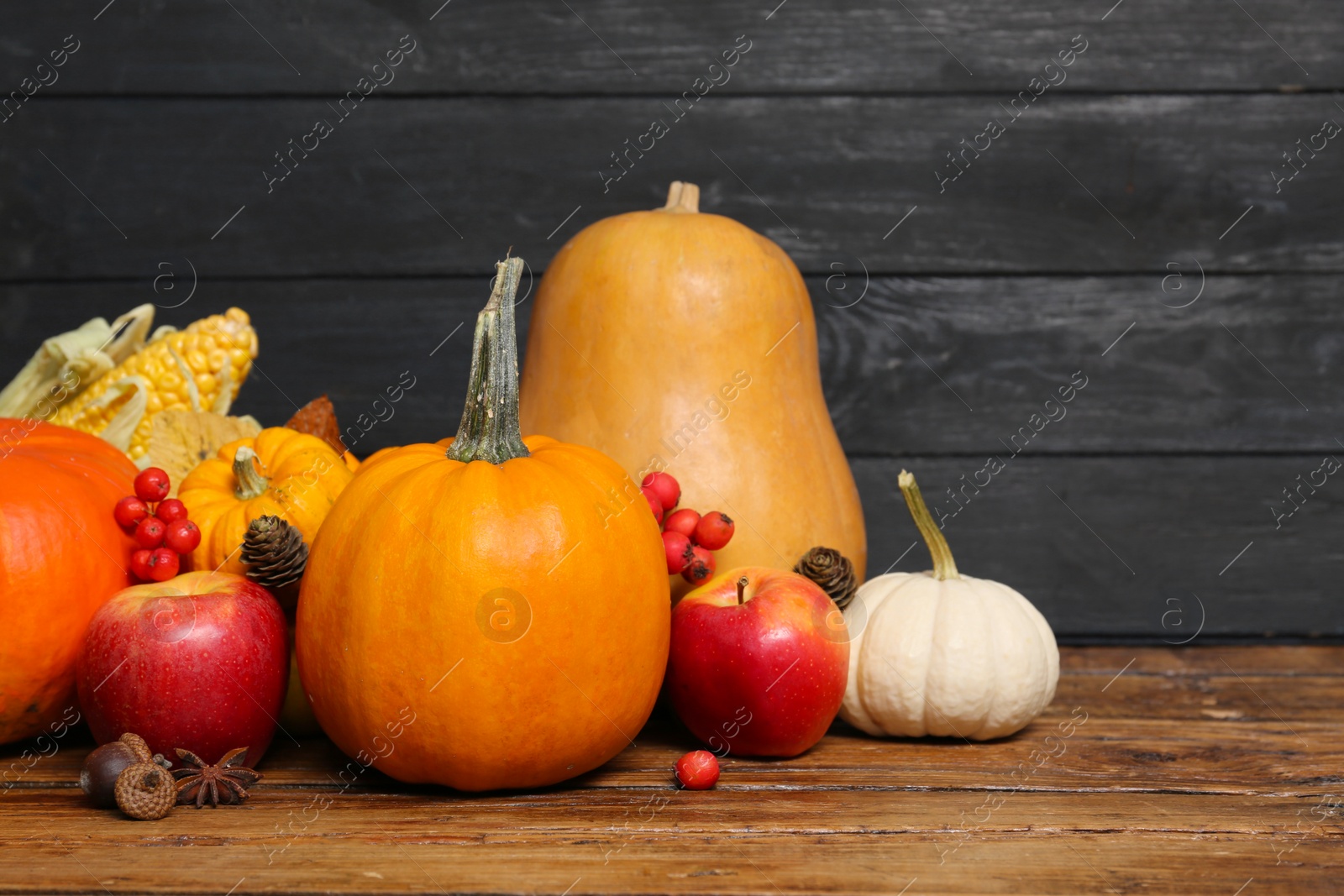 Photo of Happy Thanksgiving day. Beautiful composition with pumpkins on wooden table