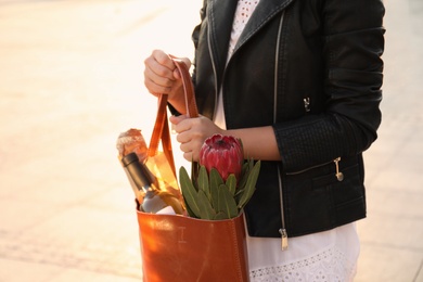 Photo of Woman with leather shopper bag outdoors, closeup