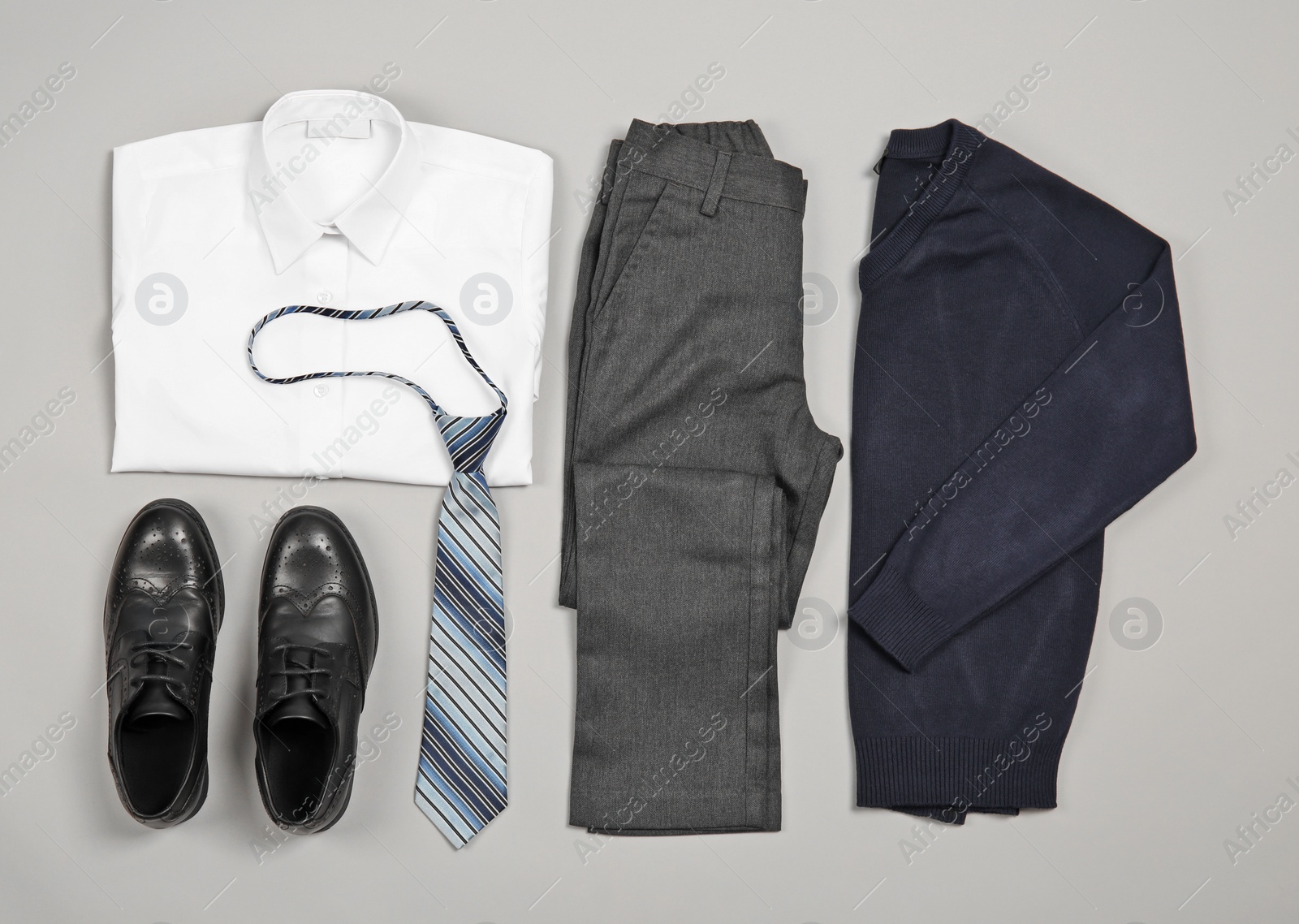 Photo of School uniform for boy on grey background, top view