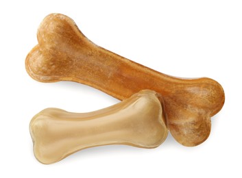 Photo of Chew bones for dog isolated on white, top view. Pet toys
