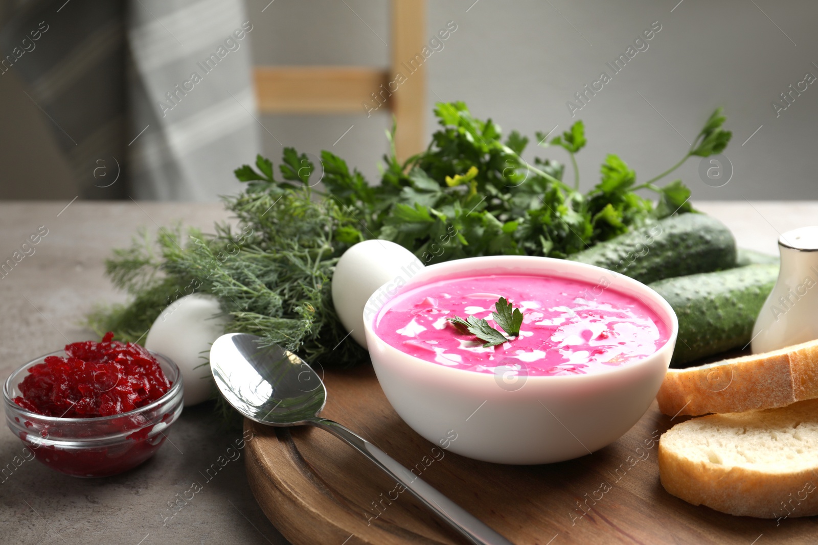 Photo of Delicious cold summer beet soup on grey table