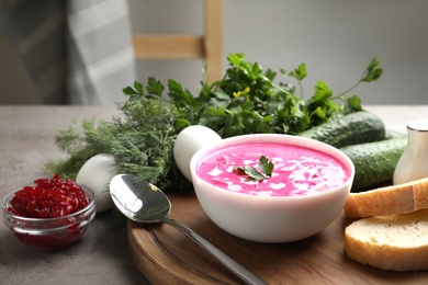 Delicious cold summer beet soup on grey table