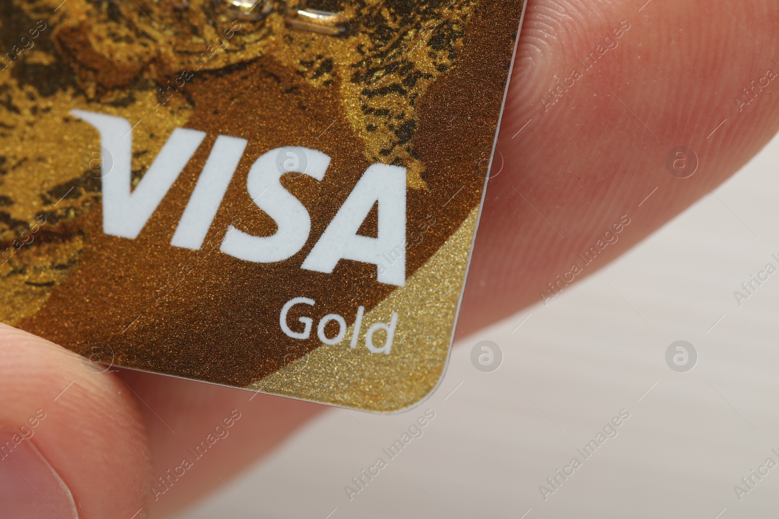 Photo of MYKOLAIV, UKRAINE - FEBRUARY 22, 2022: Woman holding Visa credit card on white background, closeup