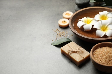 Photo of Spa composition with soap and spa items on grey table, space for text