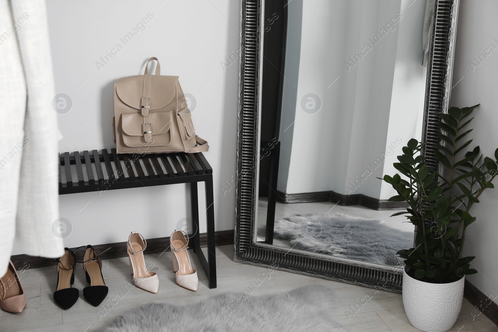 Photo of Modern hallway interior with large mirror and bench