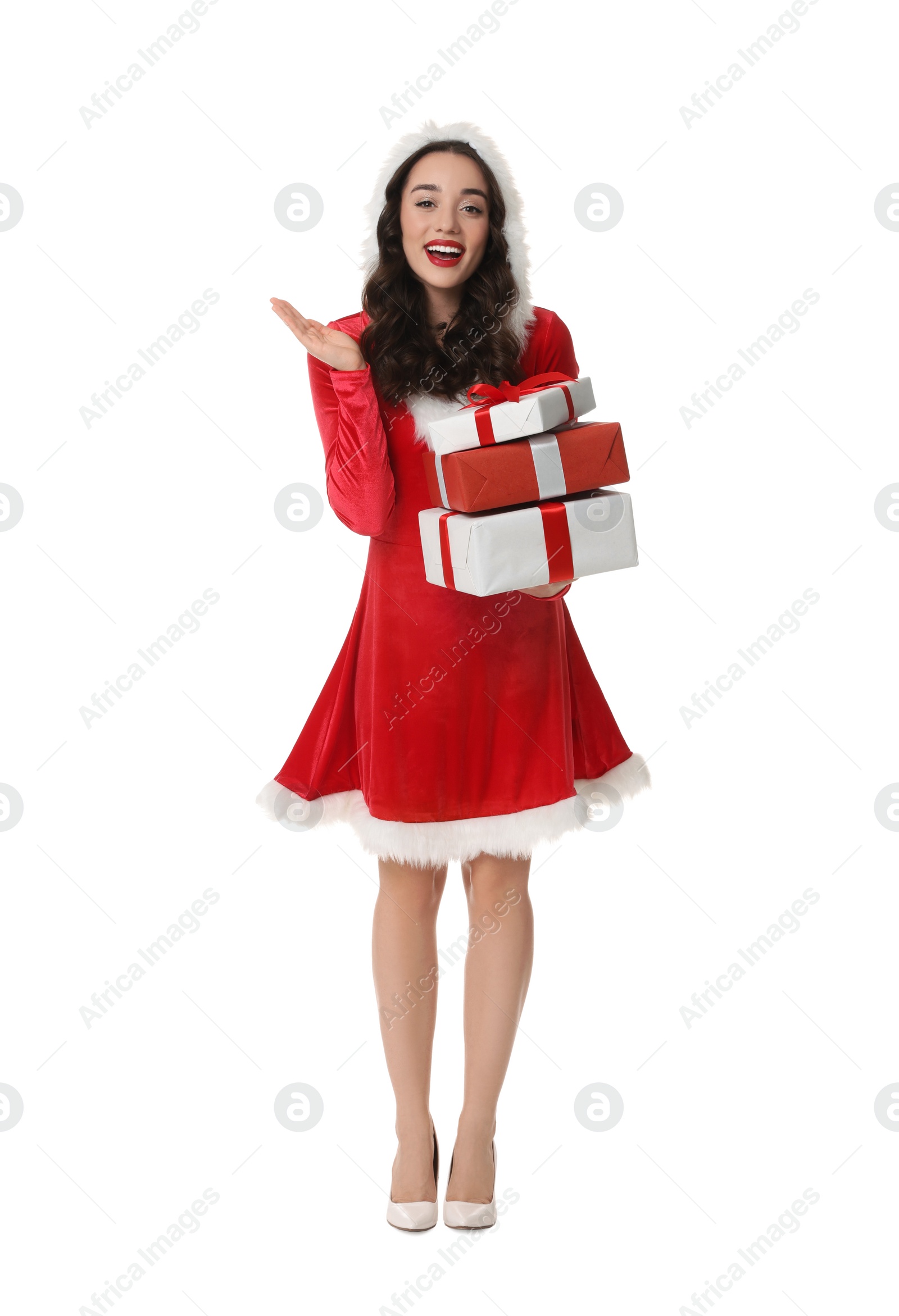 Photo of Beautiful young woman in Christmas red dress holding gift boxes isolated on white