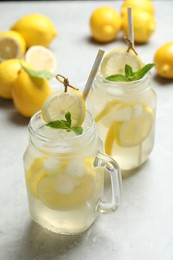 Photo of Natural lemonade with mint on light grey marble table. Summer refreshing drink