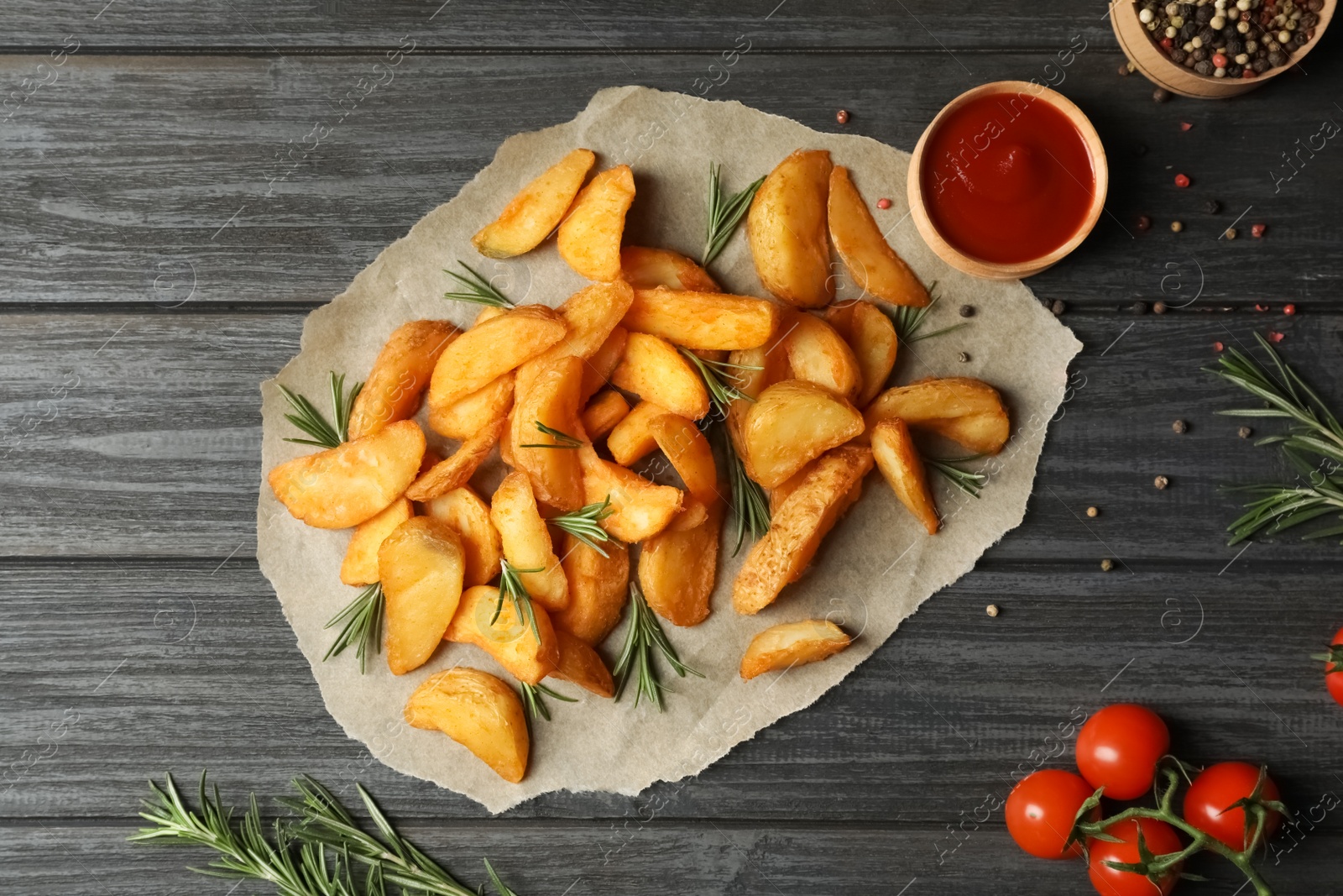 Photo of Flat lay composition with baked potatoes and rosemary on wooden background