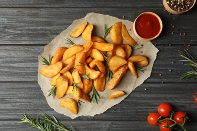 Photo of Flat lay composition with baked potatoes and rosemary on wooden background