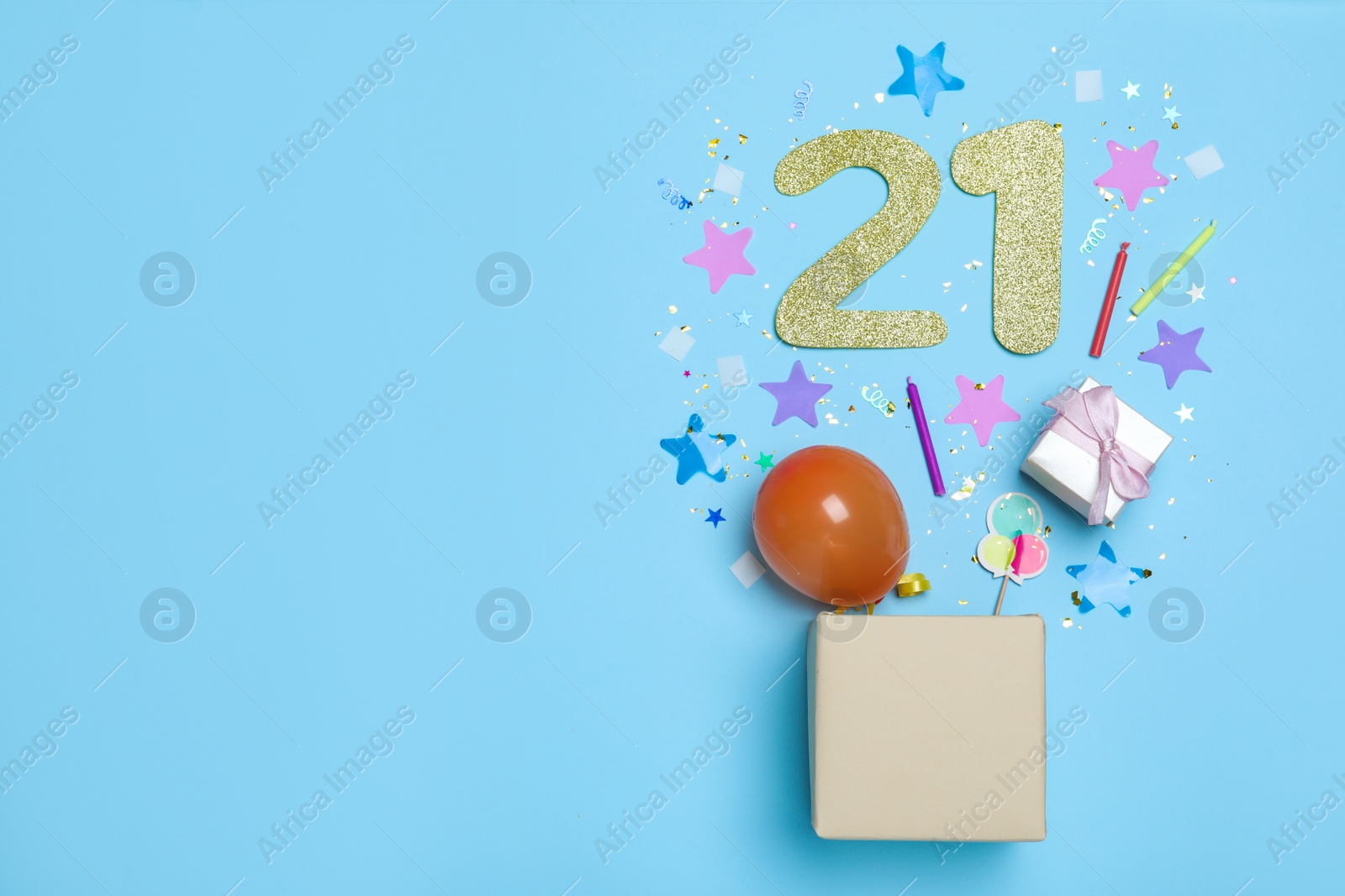 Photo of Flat lay composition with decor and numbers on light blue background, space for text. 21th birthday party