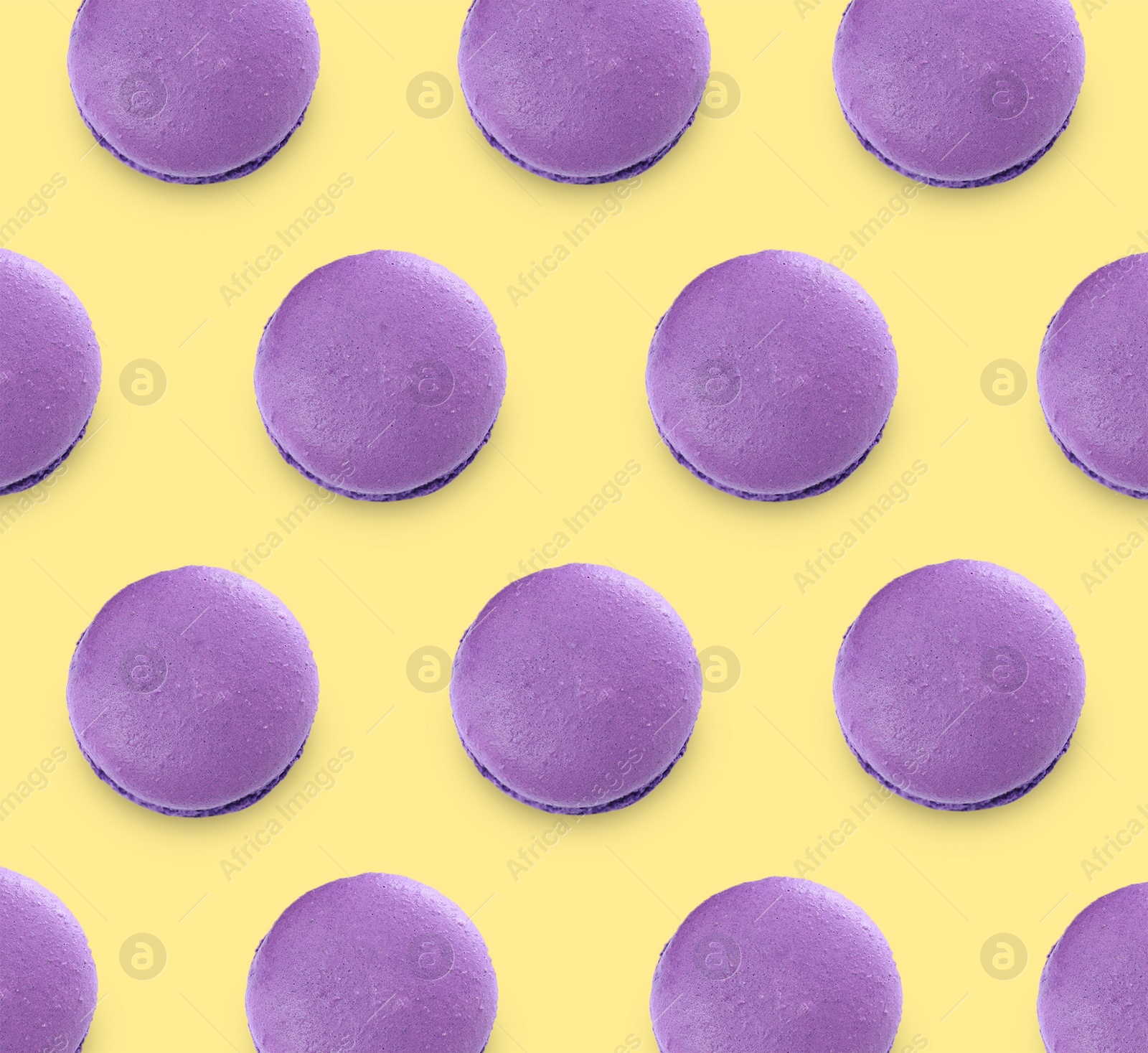Image of Delicious macarons on yellow background, flat lay 
