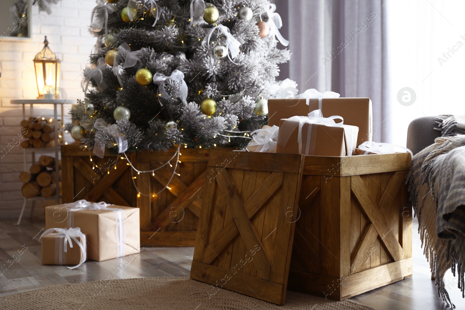 Photo of Decorated Christmas tree and gift boxes In elegant room interior