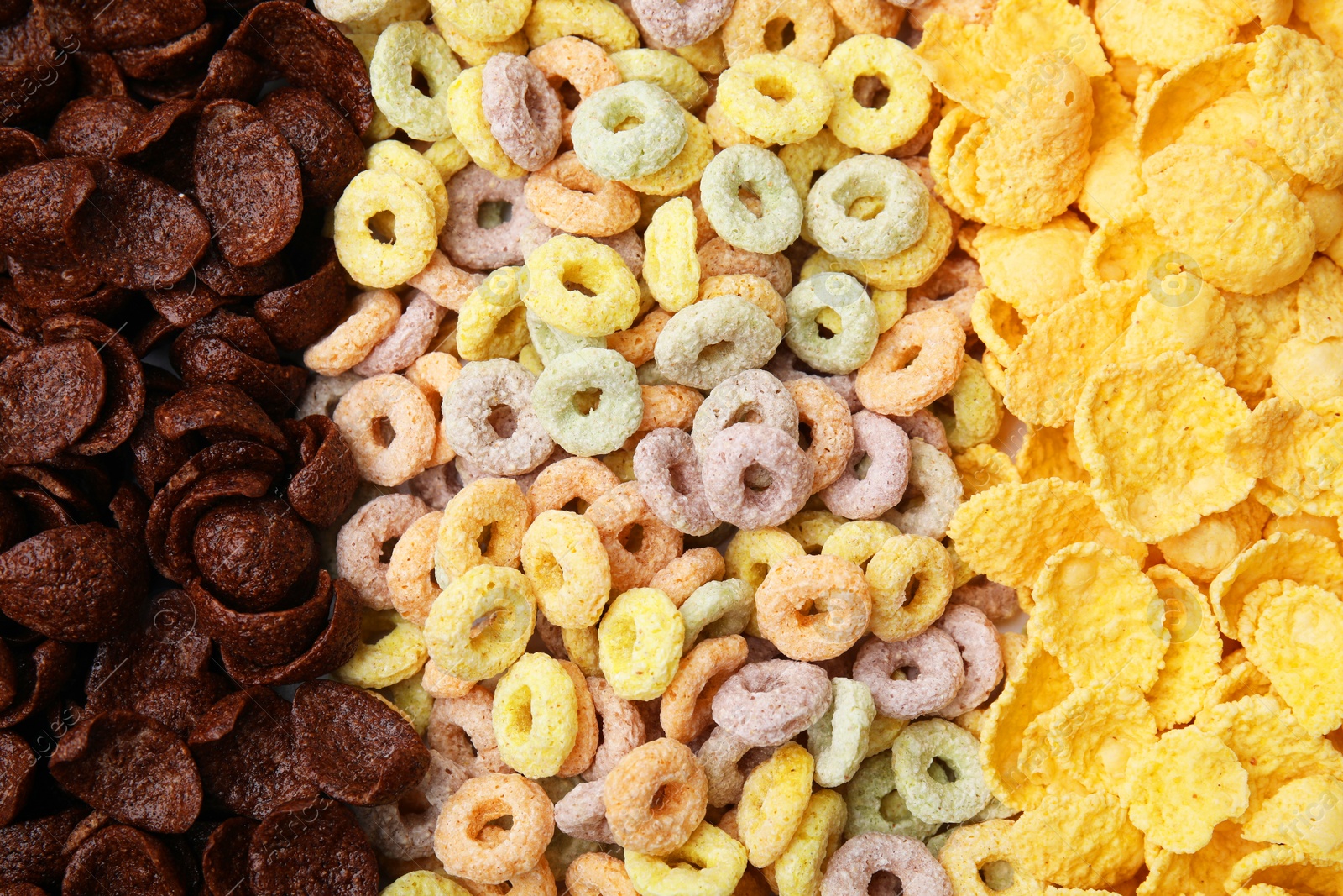 Photo of Different types of breakfast cereals as background, top view