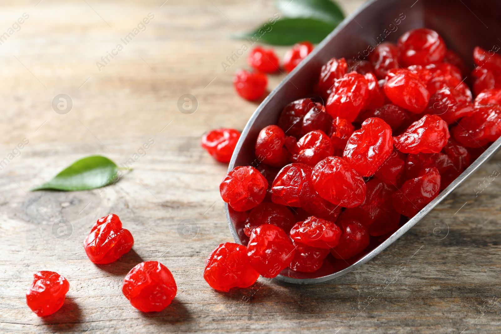 Photo of Scoop of sweet cherries on wooden background, closeup. Dried fruit as healthy snack