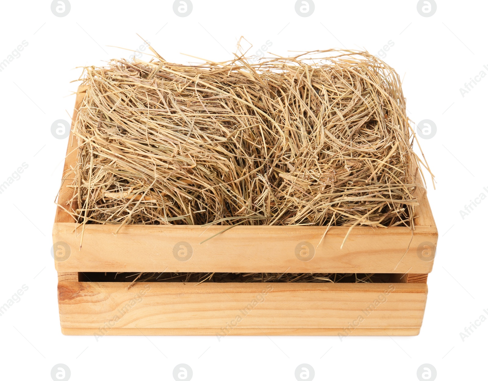 Photo of Dried hay in wooden crate on white background