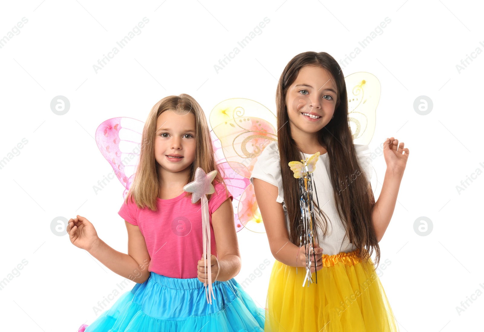 Photo of Cute little girls in fairy costumes with wings and magic wands on white background