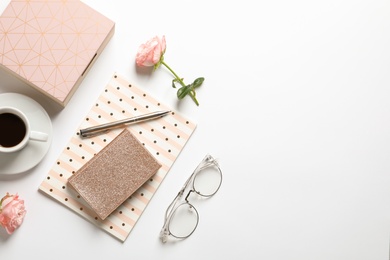 Photo of Flat lay composition with notebooks, cup of coffee and stationery on white background. Space for text