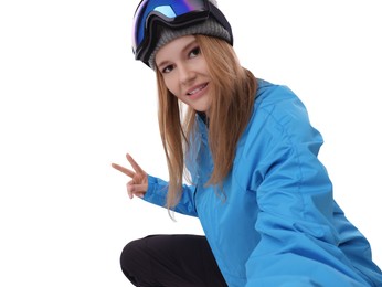 Photo of Beautiful woman in ski goggles taking selfie on white background