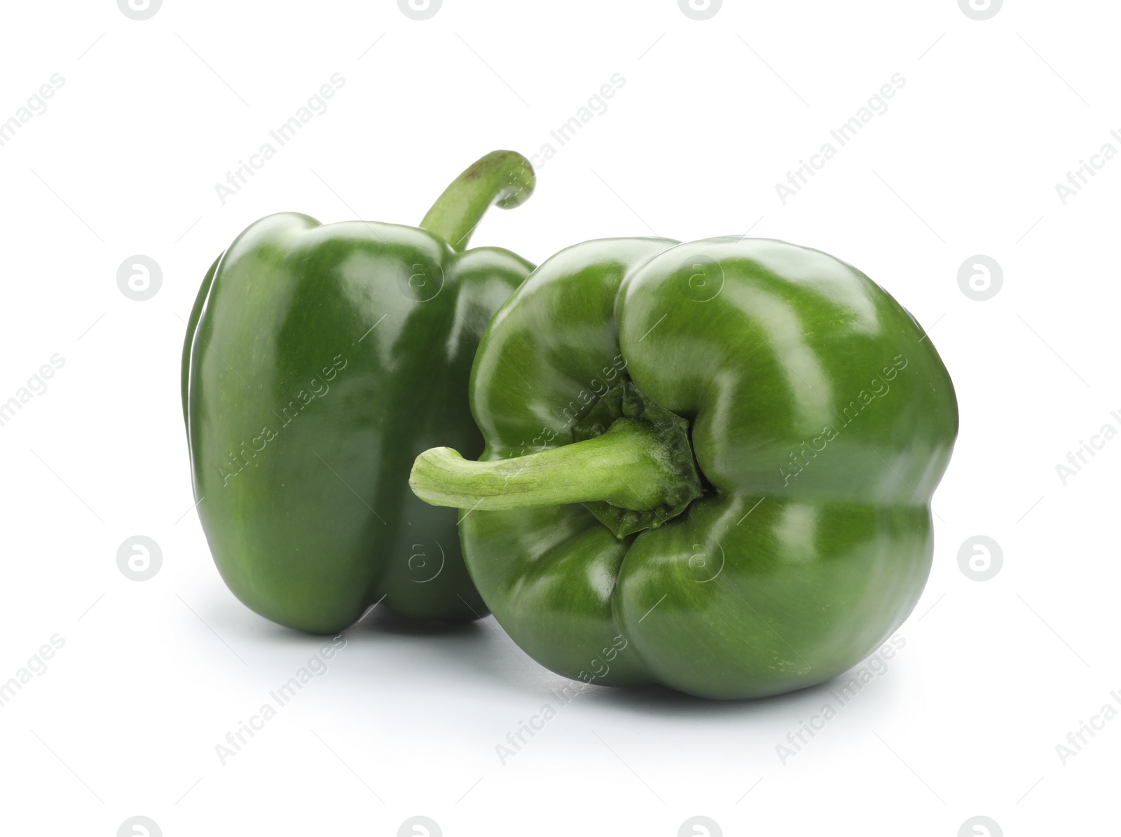 Photo of Ripe green bell peppers on white background