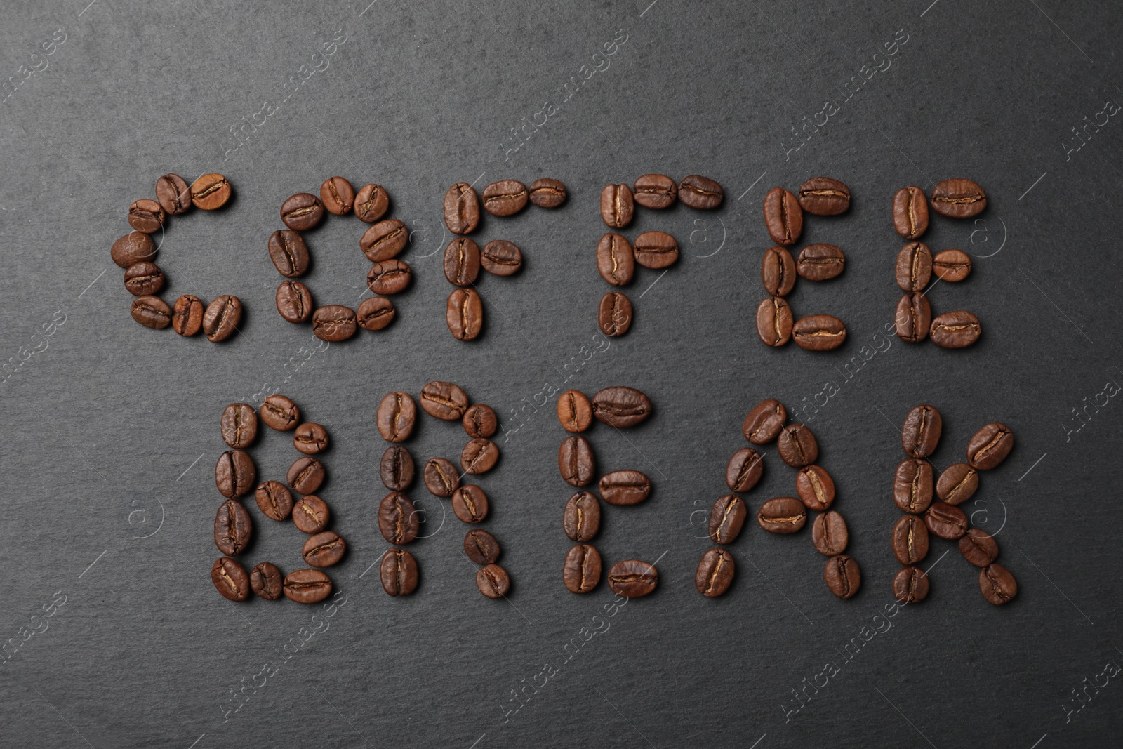 Photo of Phrase Coffee Break made of beans on black background, flat lay