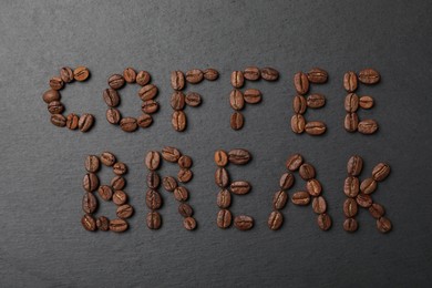 Photo of Phrase Coffee Break made of beans on black background, flat lay