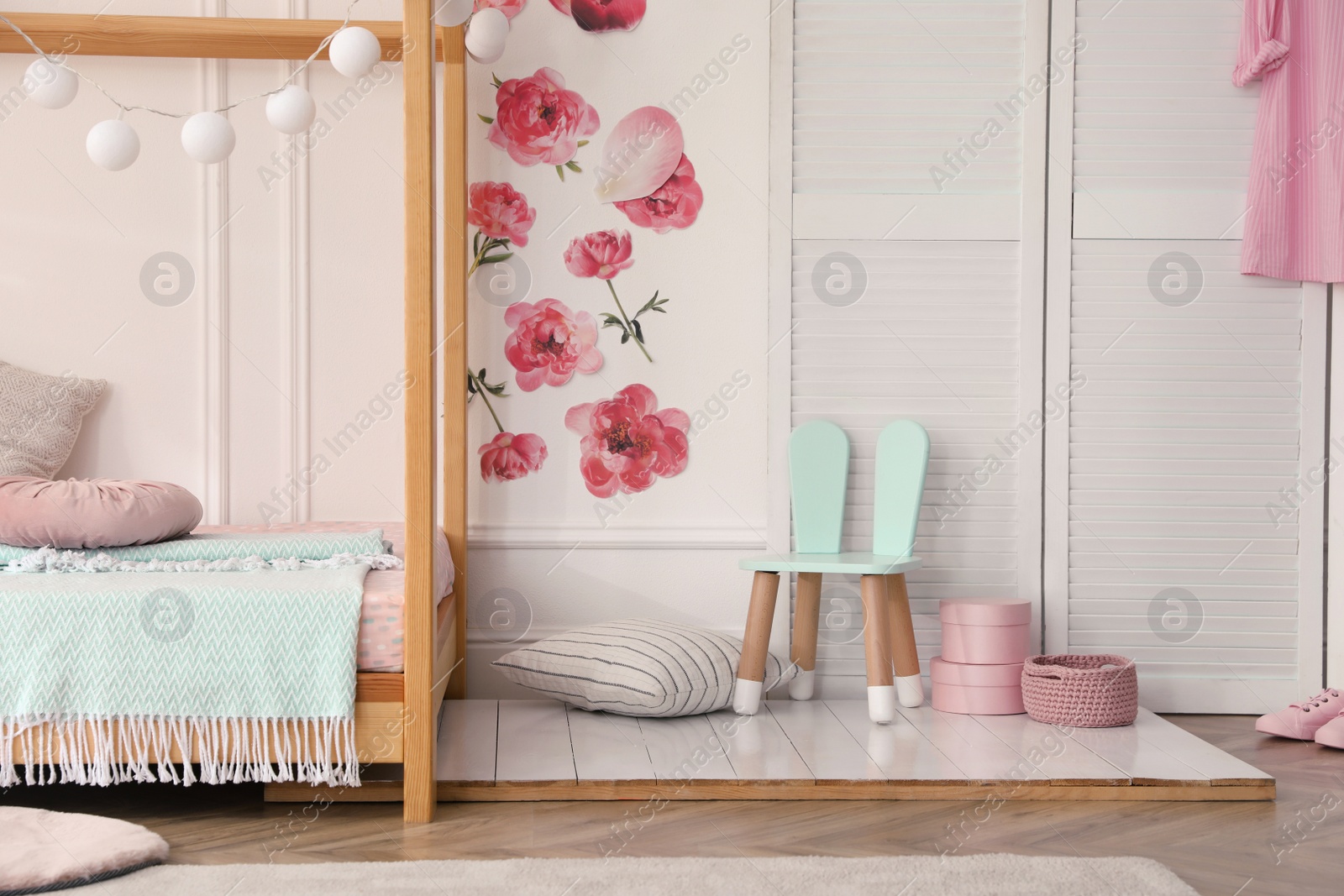 Photo of Stylish child room interior with wooden house bed