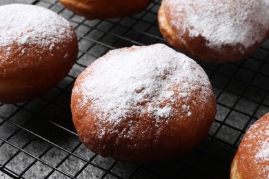 Delicious sweet buns with powdered sugar on table, closeup