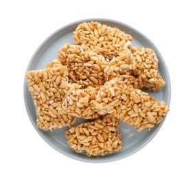 Photo of Plate with puffed rice bars (kozinaki) on white background, top view