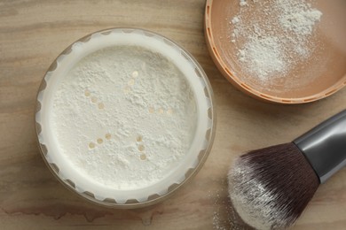 Photo of Rice loose face powder and makeup brush on brown table, flat lay