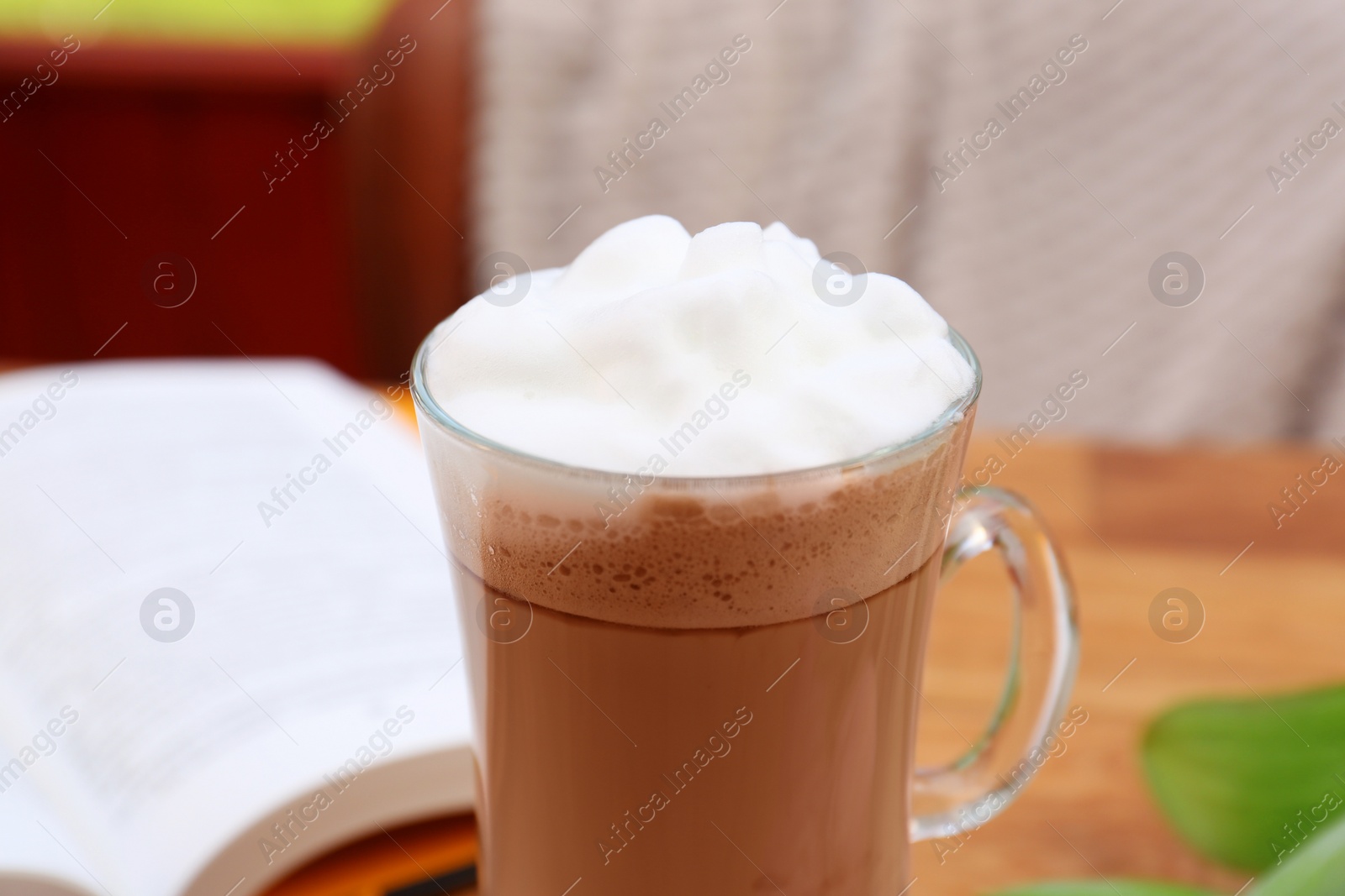 Photo of Glass of delicious cocoa with milk foam, closeup view