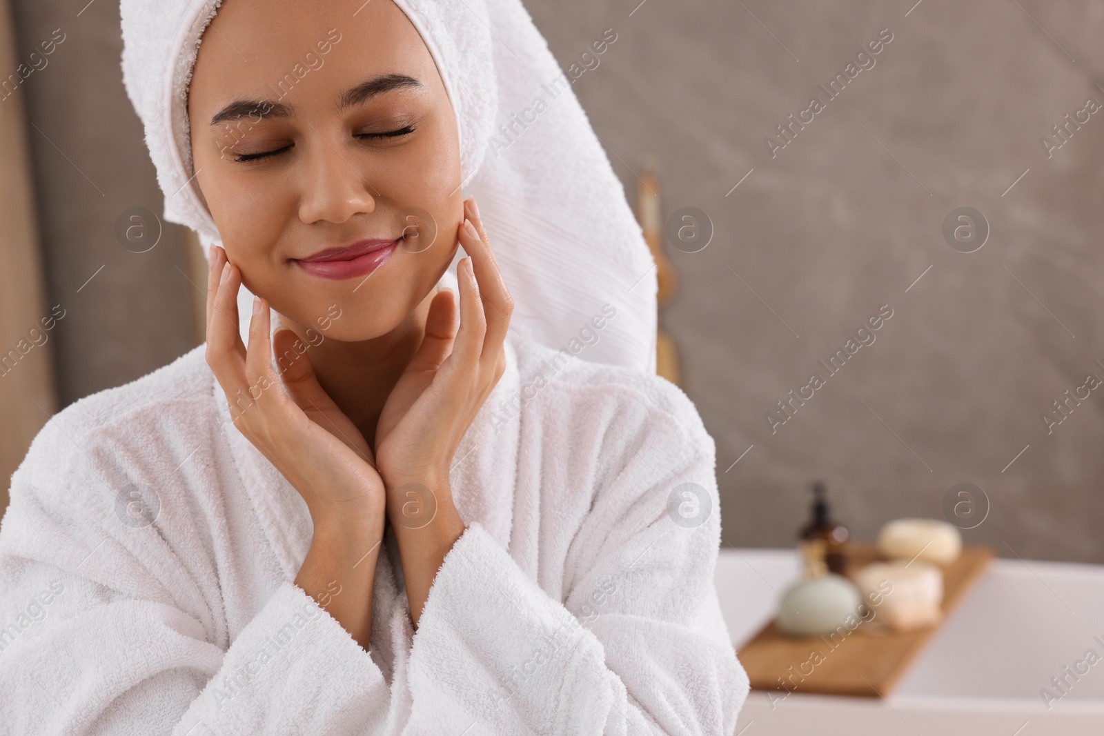 Photo of Beautiful African American woman in bathroom, space for text