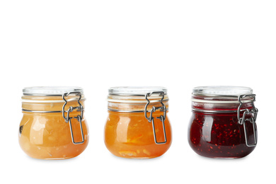 Jars of different delicious jams on white background