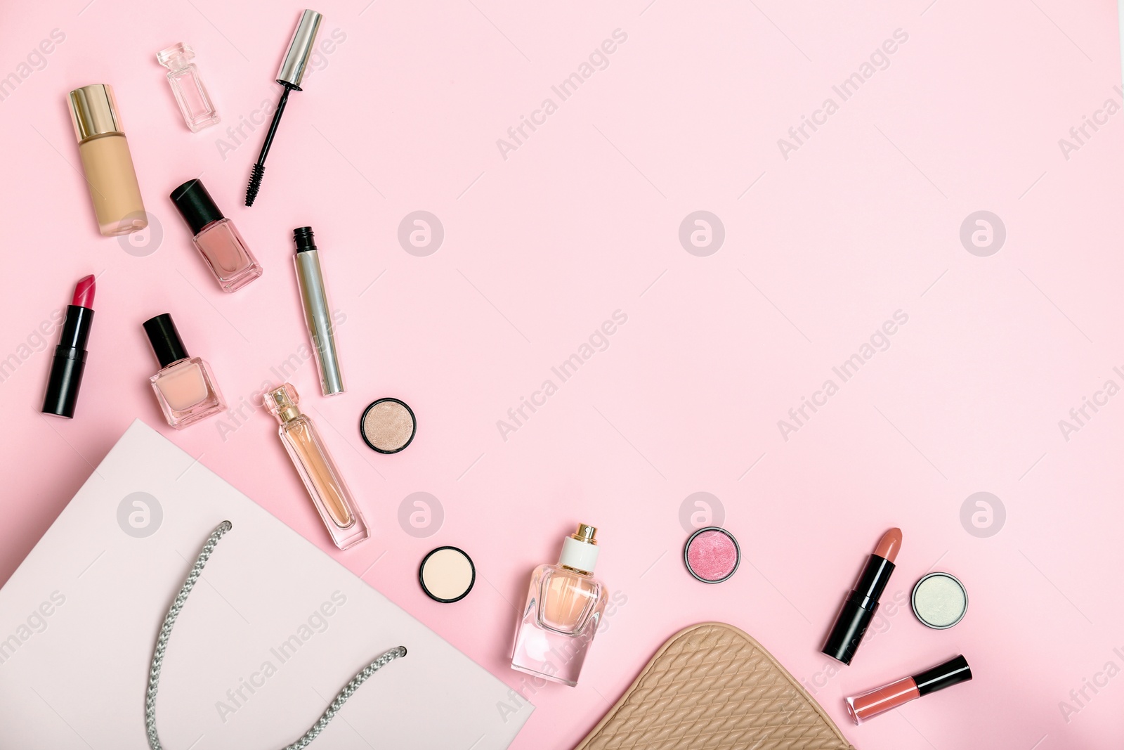 Photo of Flat lay composition with shopping bag and cosmetics on color background