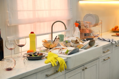 Photo of Dirty dishes in kitchen after new year party
