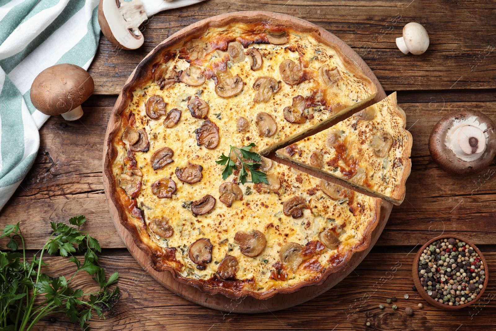 Photo of Delicious pie with mushrooms and cheese on brown wooden table, flat lay