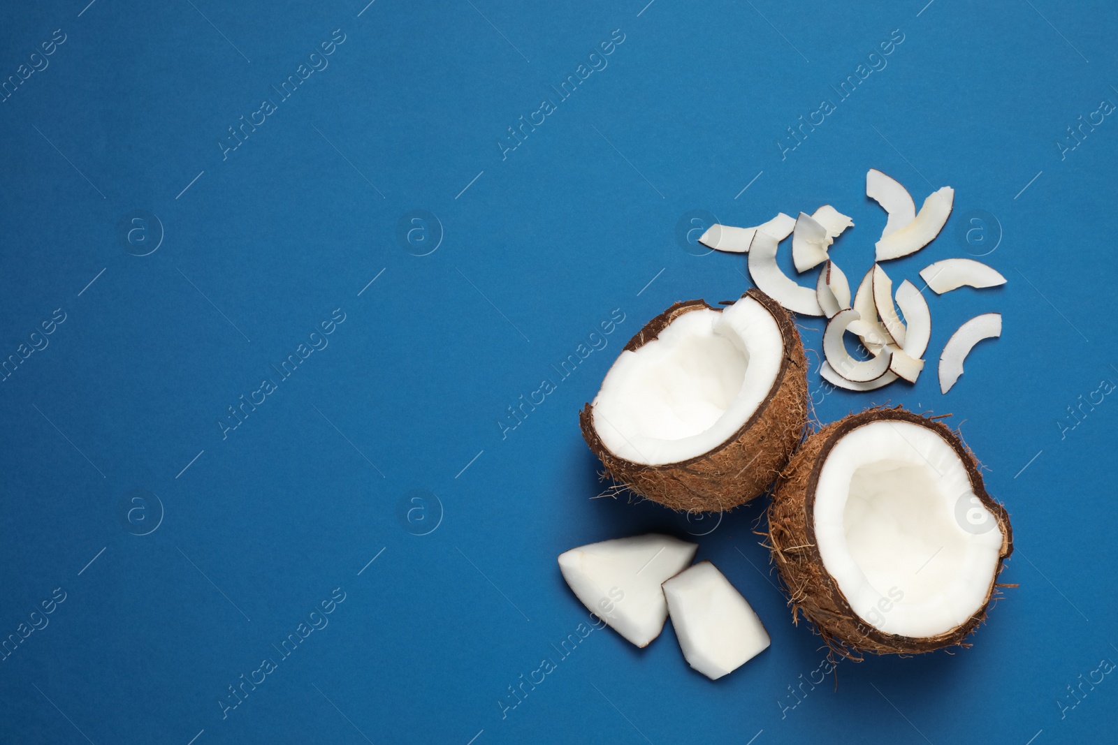 Photo of Flat lay composition with tasty coconut chips on blue background. Space for text