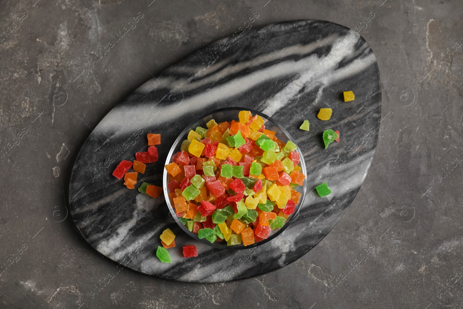Photo of Mix of delicious candied fruits on grey table, top view
