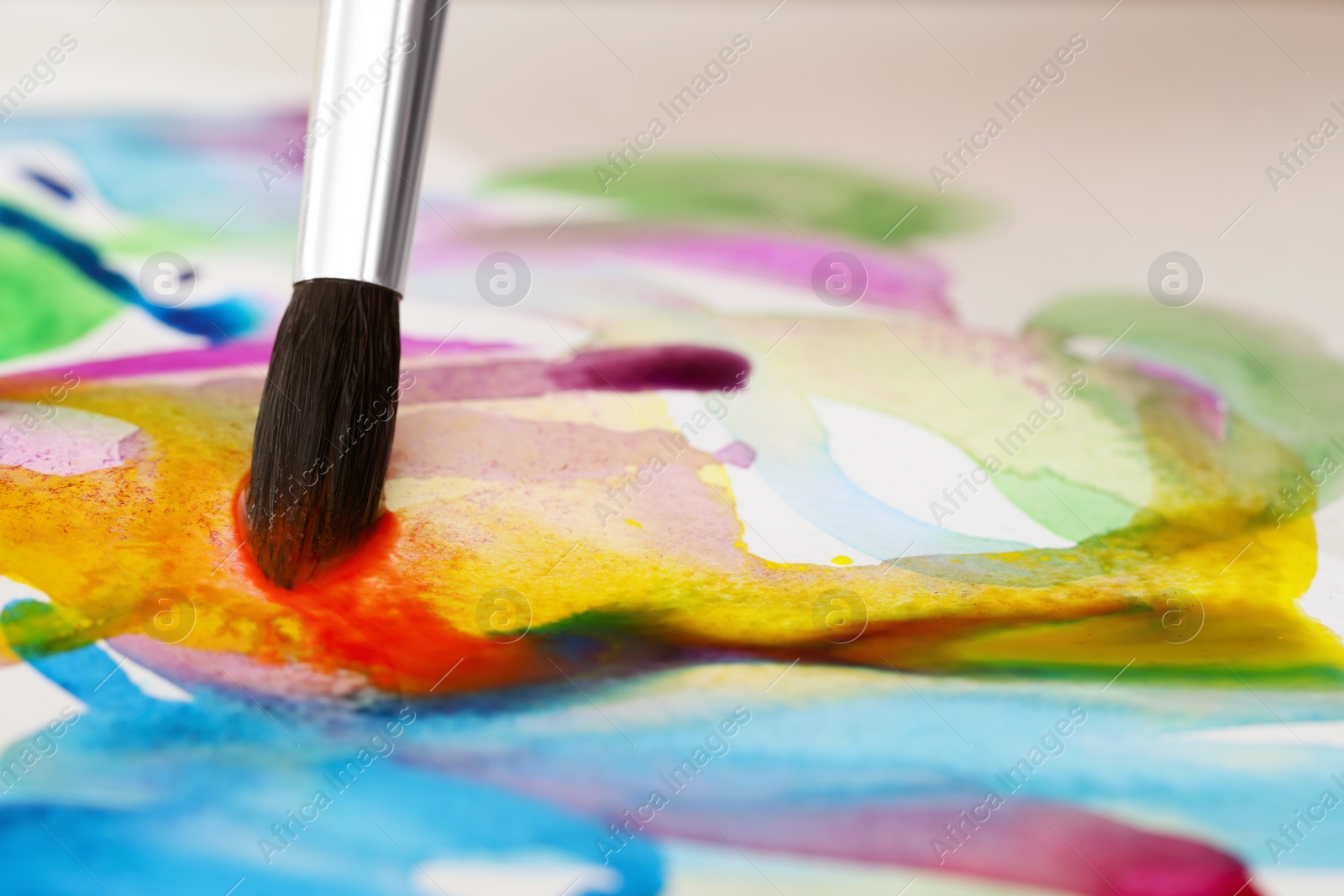 Photo of Painting with bright watercolor on paper, closeup. Space for text