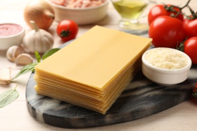Photo of Ingredients for lasagna on white wooden table, closeup
