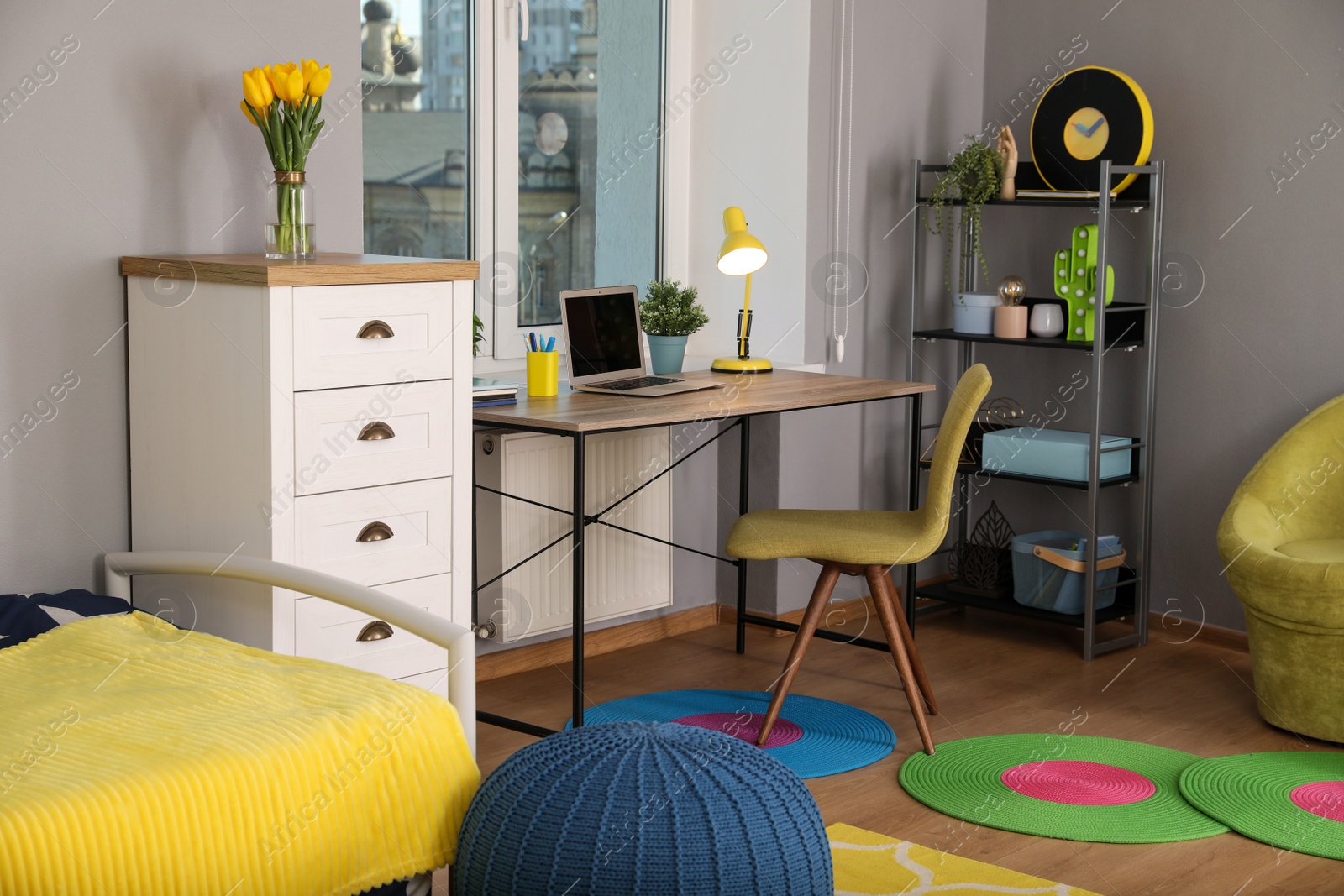 Photo of Stylish child room interior with comfortable workplace near window