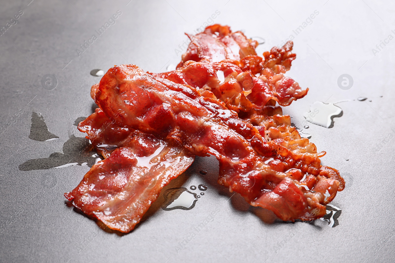 Photo of Fried bacon on grey background