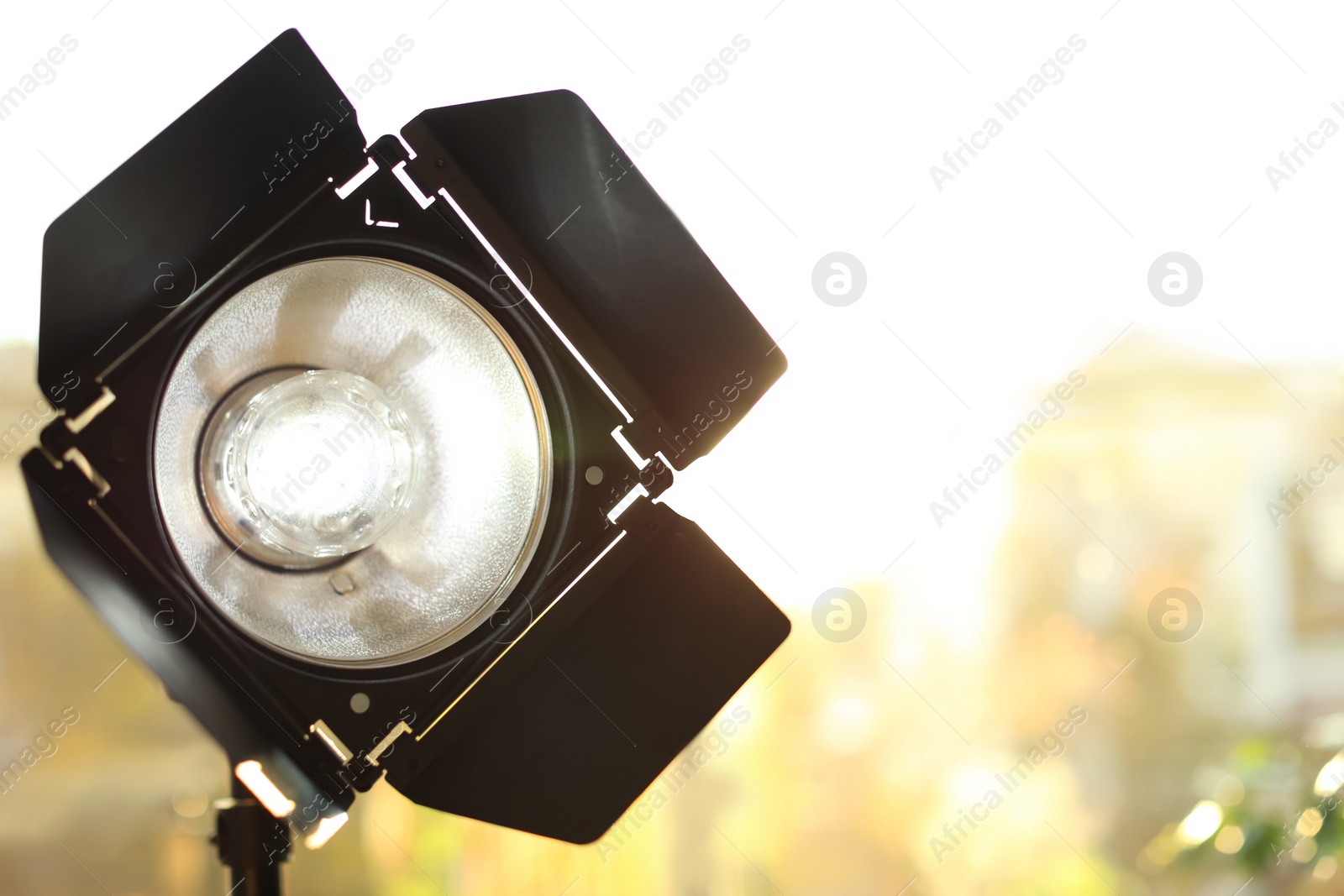 Photo of Professional photo studio lighting equipment on blurred background. Space for text