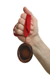 Photo of Man holding golden medal on white background, closeup. Space for design