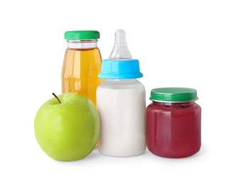 Healthy baby food, bottles with milk, juice and apple on light grey background