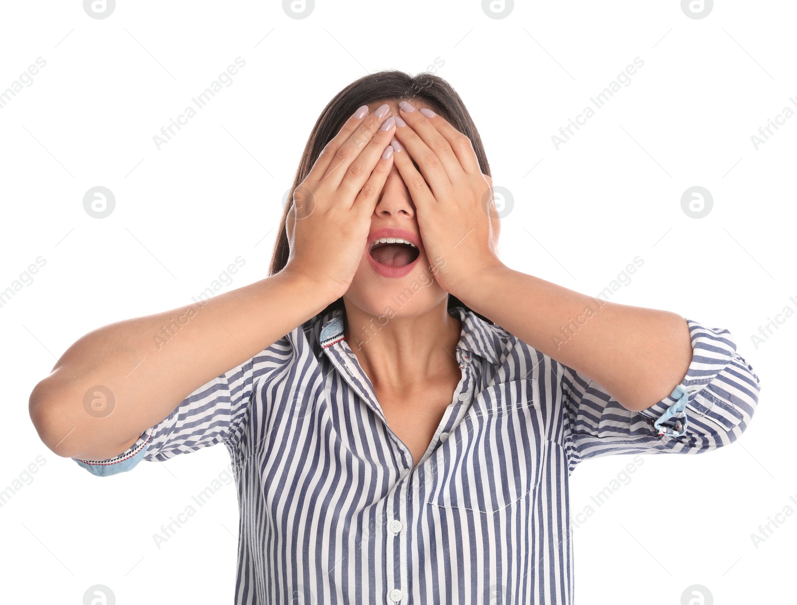 Photo of Young woman being blinded and covering eyes with hands on white background