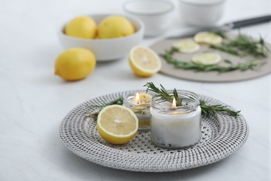Natural homemade mosquito repellent candle and ingredients on white table