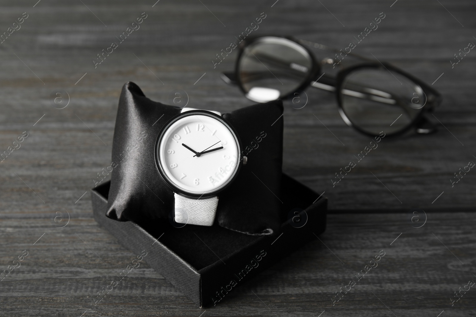 Photo of Composition with stylish wrist watch on wooden background. Fashion accessory