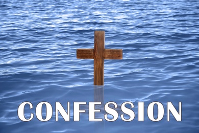 Image of Word Confession near wooden Christian cross in water